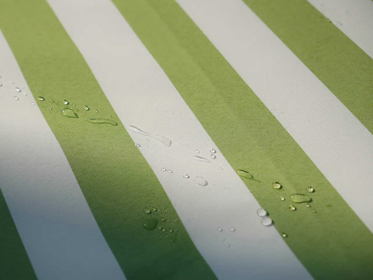 Water droplets resting on the surface of a treated striped fabric