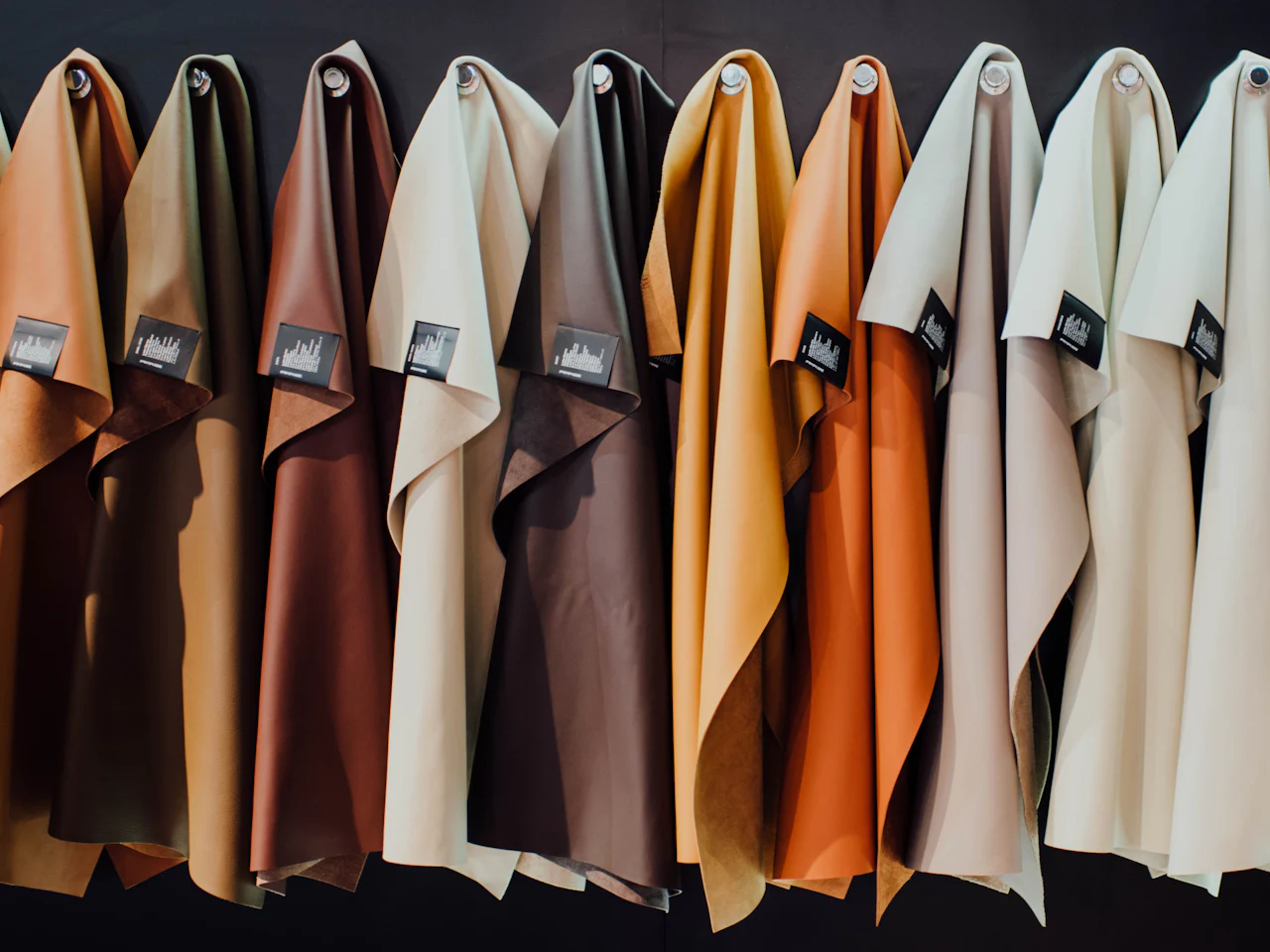 Fabric samples hung side by side in a range of tones
