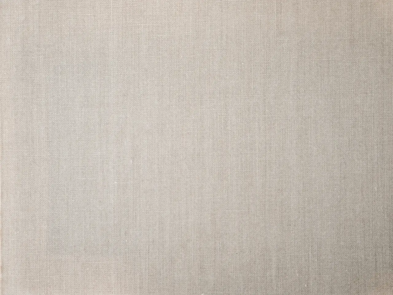 Beige linen surface showing the slub character of flax yarn