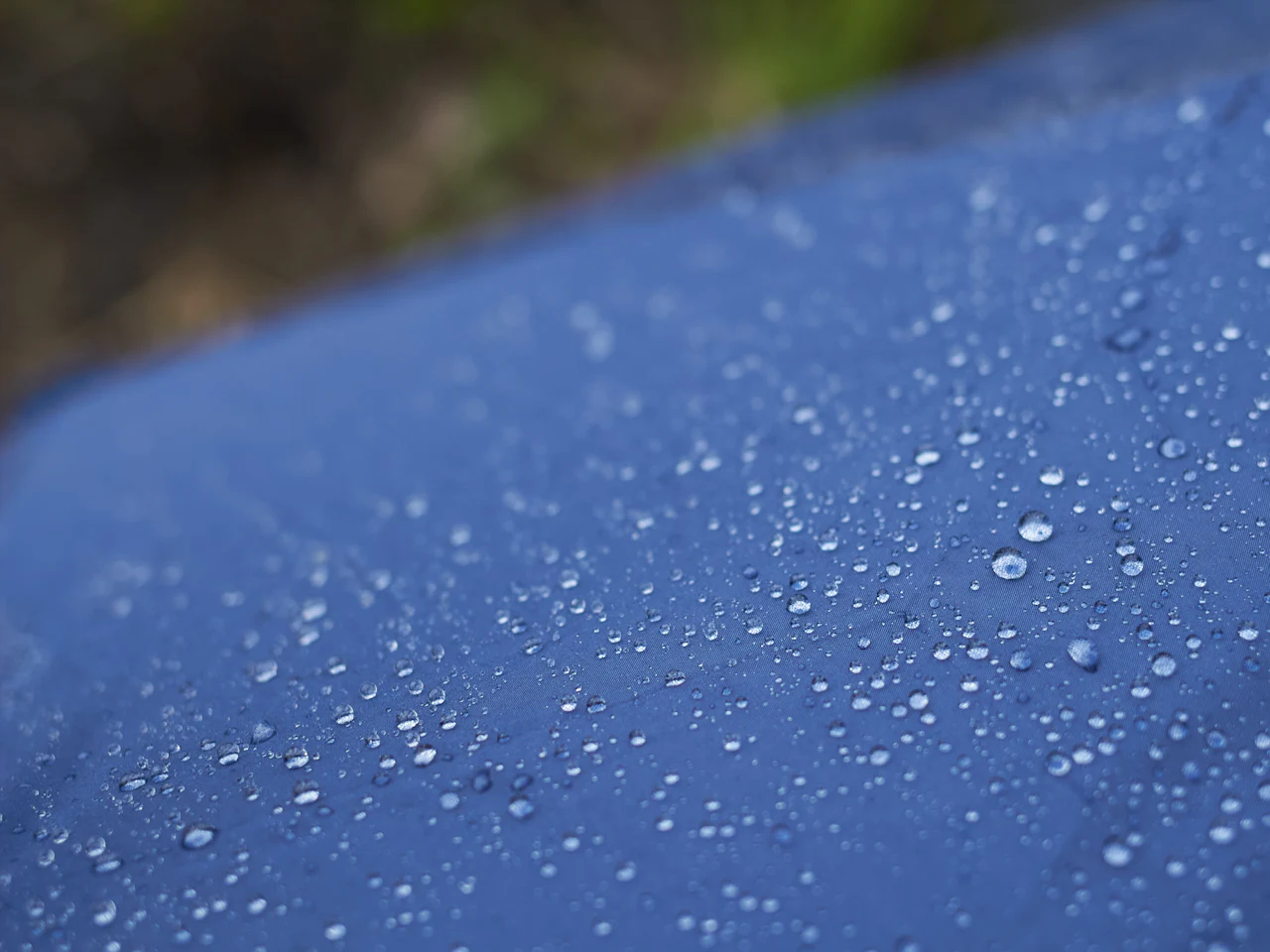 Water droplets sitting on the surface of a treated technical fabric