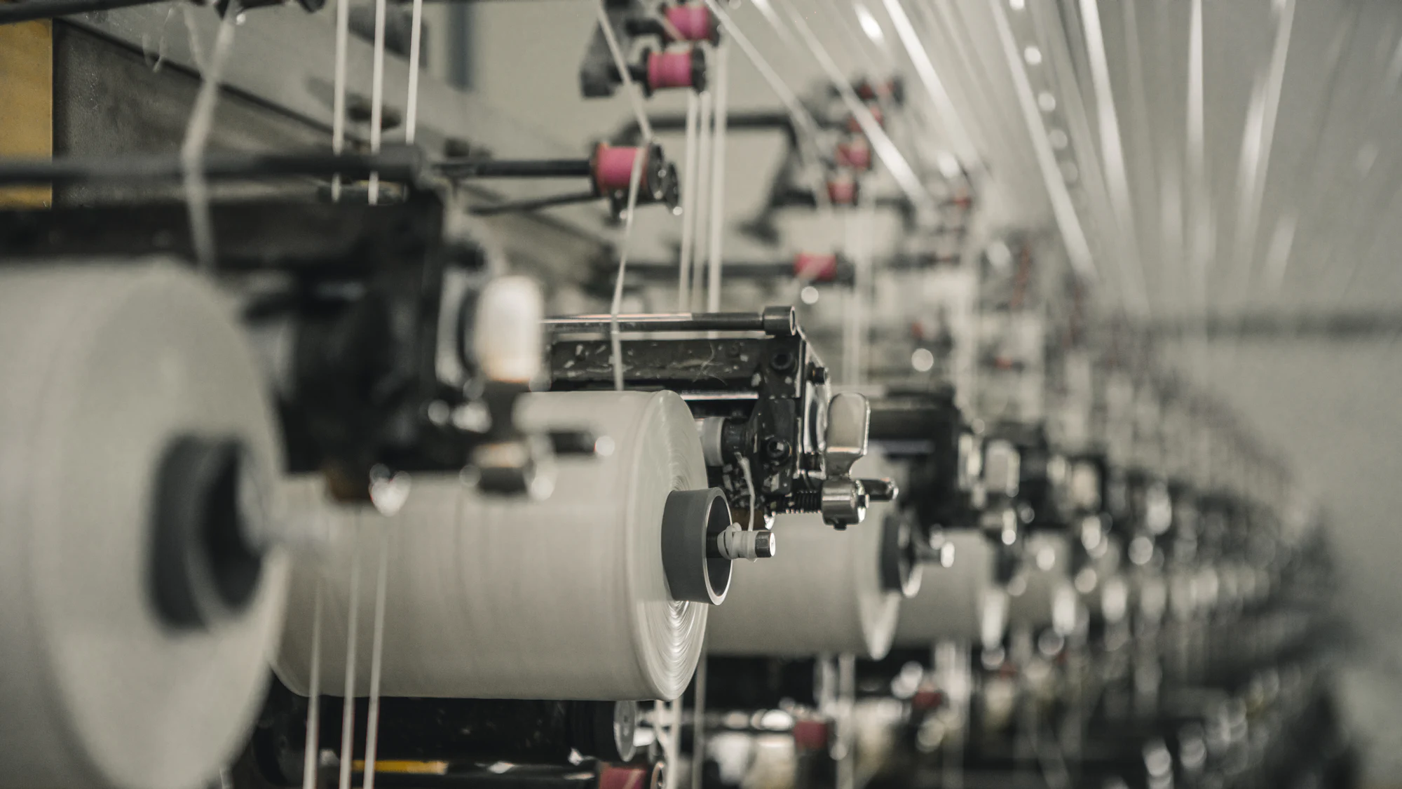 A row of spinning machines running in a textile mill