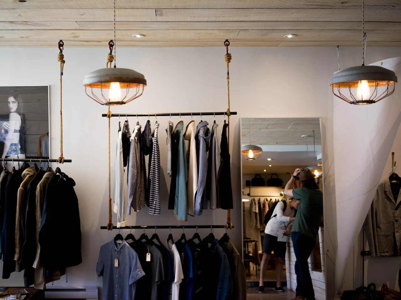 Casual garments hanging on rails in a boutique interior
