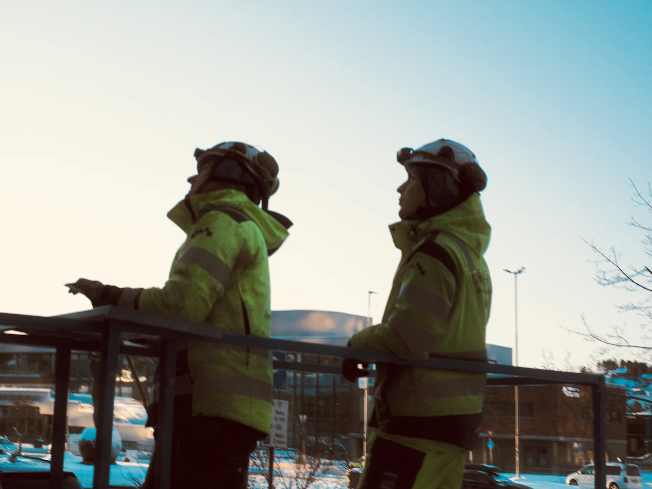 Two workers in high-visibility jackets on site